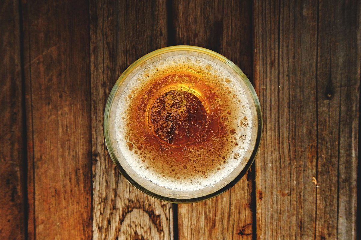 A glass on the timber counter of the Bealey Bar