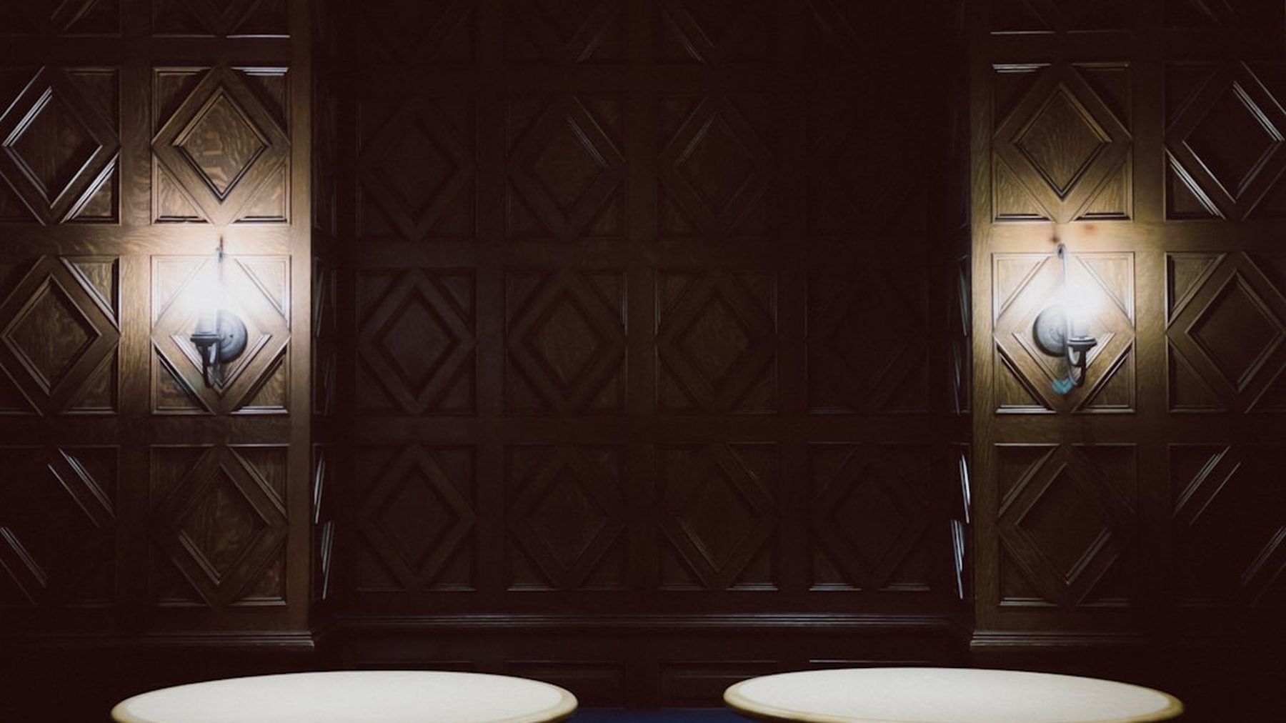 The panelled interior of the Cape Room under low light