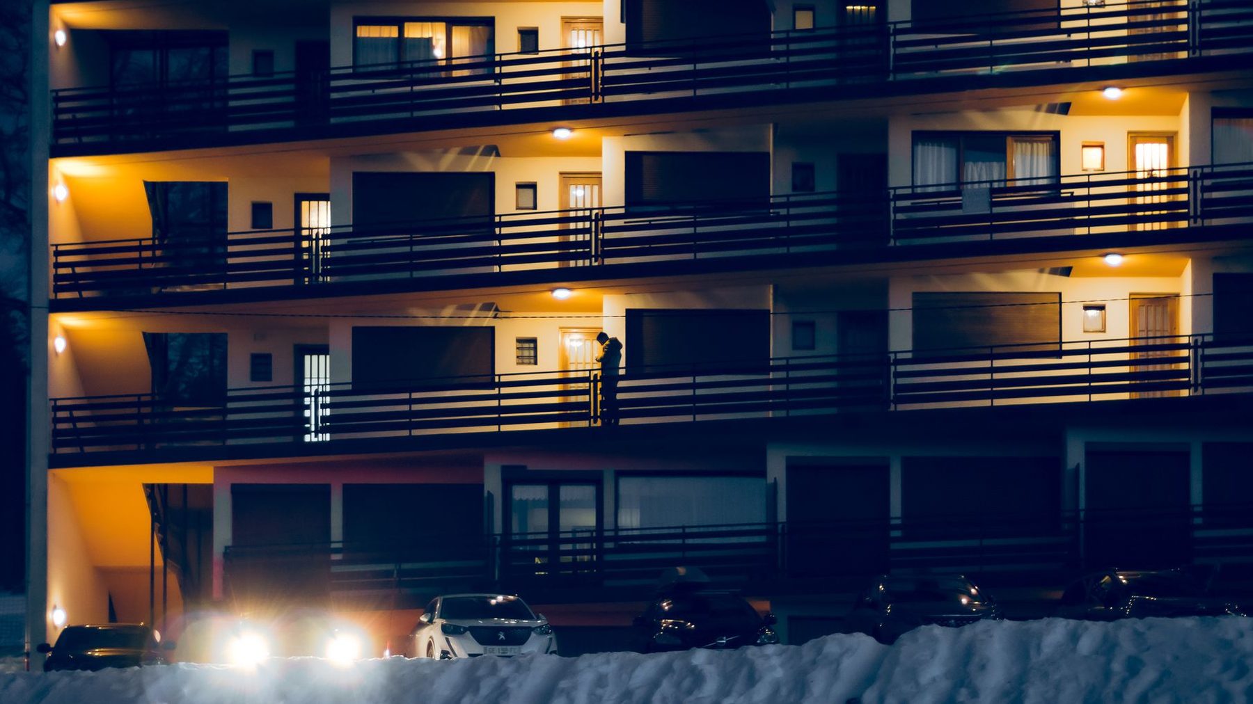 The Wintercape building on Cambridge Terrace at dusk, windows lit above the river