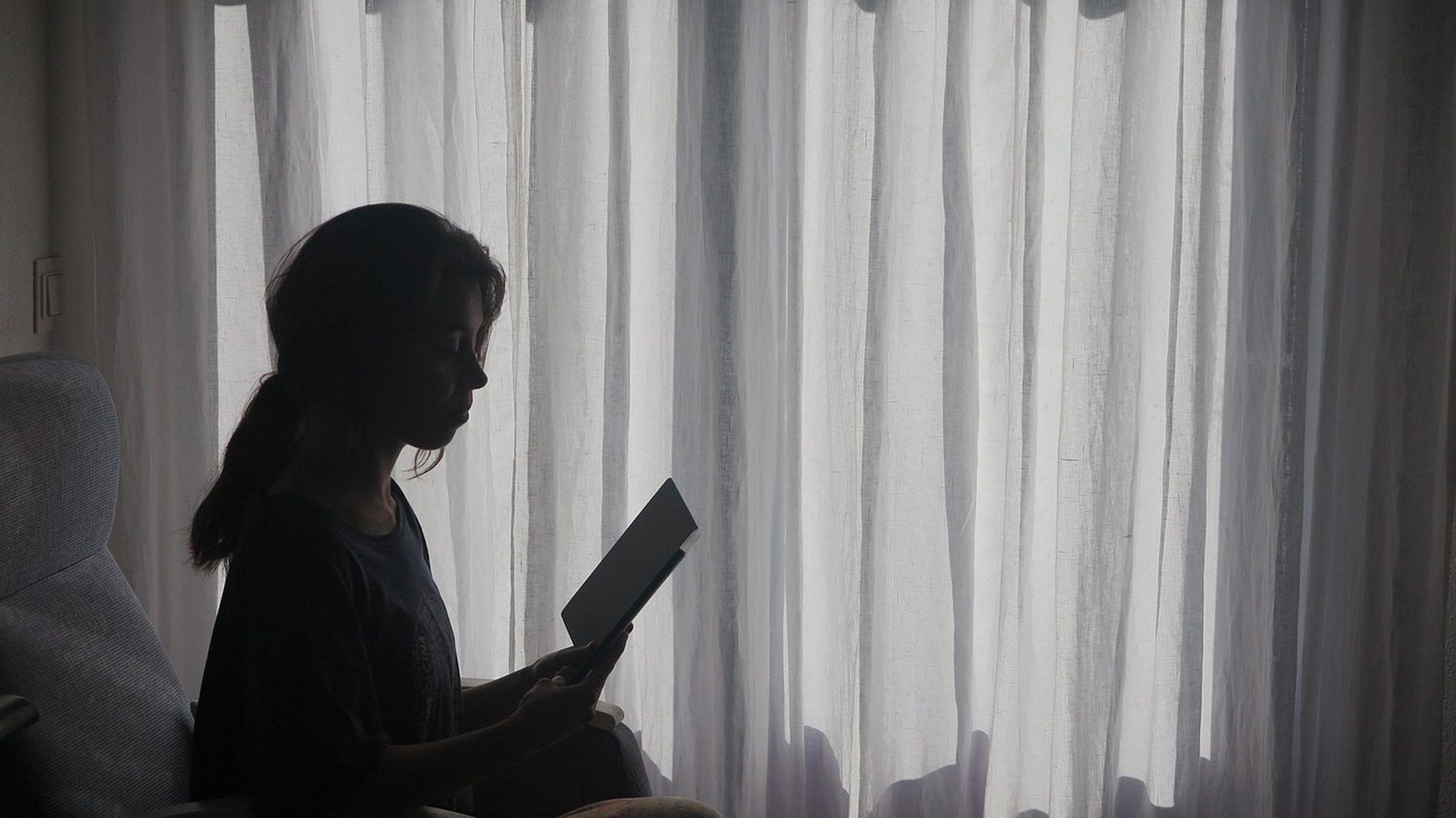 A quiet corner of the hotel with an armchair beside a window
