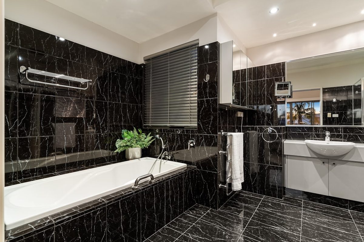 A bathroom at Wintercape with a stone basin and walk-in shower